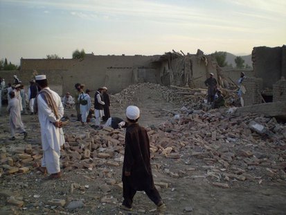 Tribesmen gather at a damaged house after a missile struck in Dandi Darpakheil village on the outskirts of Miranshah, the main town in the N Tribesmen gather at a damaged house after a missile struck in Dandi Darpakheil village on the outskirts of Miranshah, the main town in the N
