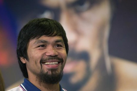 Boxer Manny Pacquiao of the Philippines smiles during a news conference in New York August 6, 2013. Pacquiao will fight Brandon Rios of the Boxer Manny Pacquiao of the Philippines smiles during a news conference in New York August 6, 2013. Pacquiao will fight Brandon Rios of the