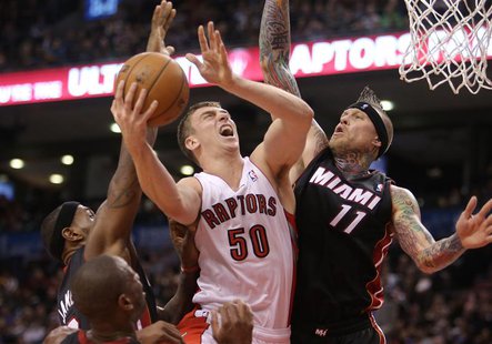 Nov 5, 2013; Toronto, Ontario, CAN; Toronto Raptors forward Tyler Hansbrough (50) is fouled as he goes to the basket against Miami Heat forw Nov 5, 2013; Toronto, Ontario, CAN; Toronto Raptors forward Tyler Hansbrough (50) is fouled as he goes to the basket against Miami Heat forw