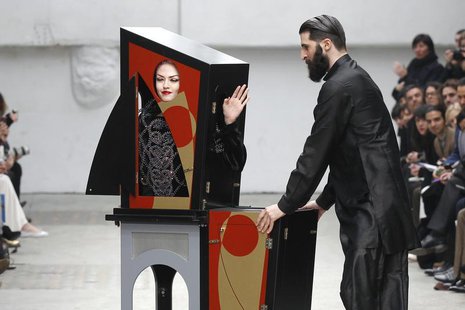 A magician performs with a model who presents a creation by Indian designer Manish Arora as part of his Fall-Winter 2011/2012 women's ready- A magician performs with a model who presents a creation by Indian designer Manish Arora as part of his Fall-Winter 2011/2012 women's ready-