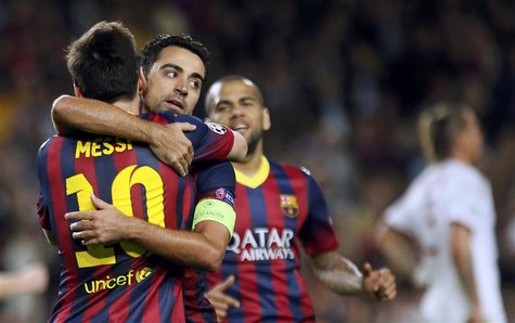 Barcelona's Lionel Messi (L) is congratulated by team mates Xavi (C) and Dani Alves after scoring his second goal against AC Milan during th Barcelona's Lionel Messi (L) is congratulated by team mates Xavi (C) and Dani Alves after scoring his second goal against AC Milan during th