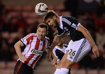 Sunderland's Phil Bardsley (L) challenges Southampton's Jos Hooiveld during their English League Cup fourth round soccer match at the Stadiu Sunderland's Phil Bardsley (L) challenges Southampton's Jos Hooiveld during their English League Cup fourth round soccer match at the Stadiu