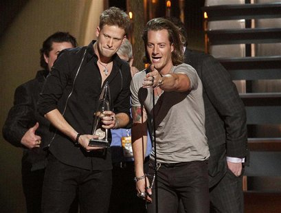 Brian Kelley (L) and Tyler Hubbard (R) of Florida Georgia Line accept the award for single of the year for "Cruise" at the 47th Country Musi Brian Kelley (L) and Tyler Hubbard (R) of Florida Georgia Line accept the award for single of the year for "Cruise" at the 47th Country Musi