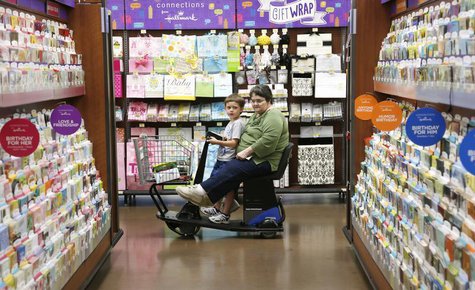 A woman riding an electric cart shops with a child at a Walmart Supercenter in Rogers, Arkansas June 6, 2013. REUTERS/Rick Wilking A woman riding an electric cart shops with a child at a Walmart Supercenter in Rogers, Arkansas June 6, 2013. REUTERS/Rick Wilking