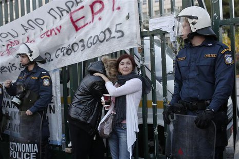 Former employees of the Greek state television ERT comfort each other outside its headquarters at Agia Paraskevi suburb north of Athens Nove Former employees of the Greek state television ERT comfort each other outside its headquarters at Agia Paraskevi suburb north of Athens Nove