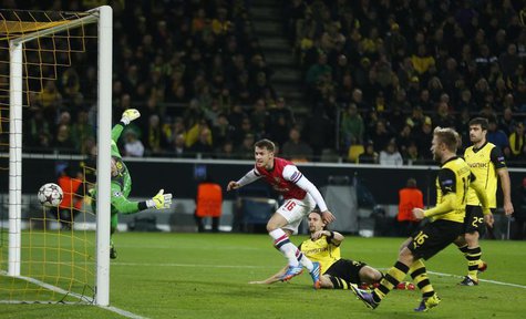 Arsenal's Aaron Ramsey (C) scores a goal past Borussia Dortmund's goalkeeper Roman Weidenfeller during their Champions League Group F soccer Arsenal's Aaron Ramsey (C) scores a goal past Borussia Dortmund's goalkeeper Roman Weidenfeller during their Champions League Group F soccer