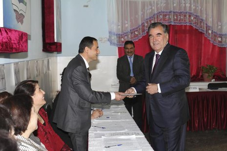 Tajikistan's President Imomali Rakhmon (R) receives his ballot from an electoral official during the presidential election in Dushanbe, in t Tajikistan's President Imomali Rakhmon (R) receives his ballot from an electoral official during the presidential election in Dushanbe, in t
