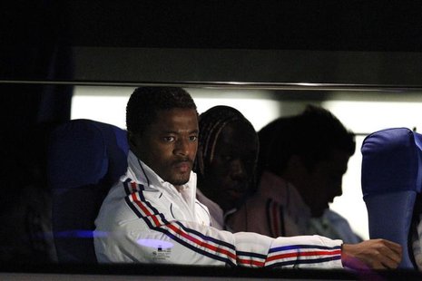 France's national soccer player Patrice Evra (L) sits in the team bus after arriving at the airport in Bloemfontein June 21, 2010. FREUTERS/ France's national soccer player Patrice Evra (L) sits in the team bus after arriving at the airport in Bloemfontein June 21, 2010. FREUTERS/