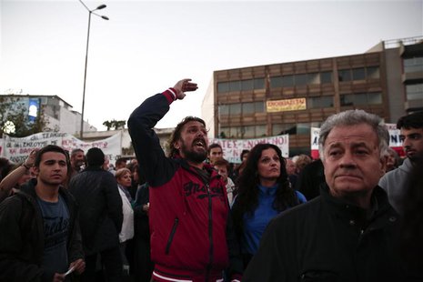 A protester yells at policemen during a rally outside former state television ERT headquarters at Agia Paraskevi suburb north of Athens Nove A protester yells at policemen during a rally outside former state television ERT headquarters at Agia Paraskevi suburb north of Athens Nove