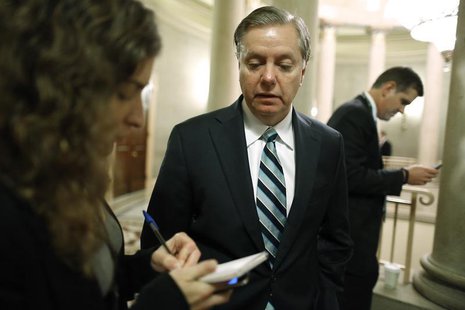 U.S. Senator Lindsey Graham (C) talks to a reporter as he arrives for a Republican Senate caucus meeting at the U.S. Capitol in Washington, U.S. Senator Lindsey Graham (C) talks to a reporter as he arrives for a Republican Senate caucus meeting at the U.S. Capitol in Washington,