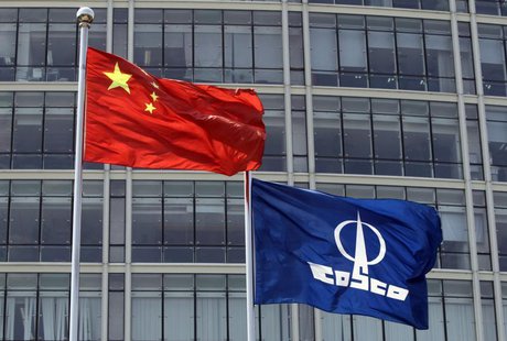 A COSCO company flag and a Chinese national flag fly in front of the company's headquarters in Beijing August 26, 2010. REUTERS/Barry Huang A COSCO company flag and a Chinese national flag fly in front of the company's headquarters in Beijing August 26, 2010. REUTERS/Barry Huang