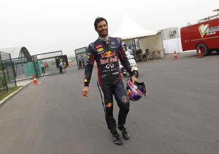 Red Bull Formula One driver Mark Webber of Australia returns to the garage area after retiring from the race during the Indian F1 Grand Prix Red Bull Formula One driver Mark Webber of Australia returns to the garage area after retiring from the race during the Indian F1 Grand Prix