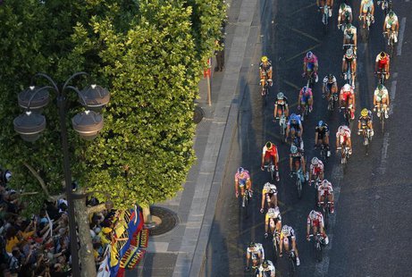 The pack of riders cycles on the Champs Elysees avenue during the 133.5km final stage of the centenary Tour de France cycling race from Vers The pack of riders cycles on the Champs Elysees avenue during the 133.5km final stage of the centenary Tour de France cycling race from Vers