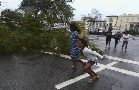 Residents rush to safety past a fallen tree during strong winds brought by Typhoon Haiyan that hit Cebu city, central Philippines November 8 Residents rush to safety past a fallen tree during strong winds brought by Typhoon Haiyan that hit Cebu city, central Philippines November 8