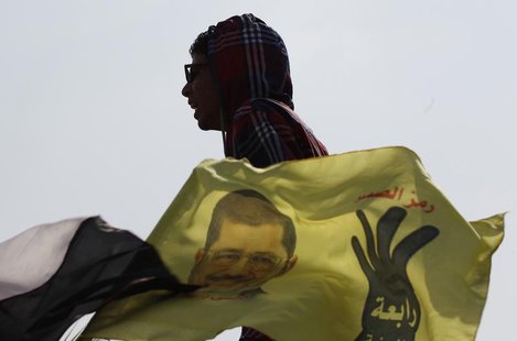 A supporter of the Muslim Brotherhood and ousted Egyptian President Mohamed Mursi shouts slogans outside the police academy, where Mursi's t A supporter of the Muslim Brotherhood and ousted Egyptian President Mohamed Mursi shouts slogans outside the police academy, where Mursi's t