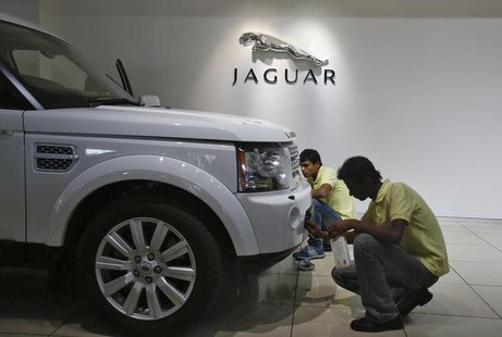 Showroom attendants polish a vehicle under a Jaguar logo at a Jaguar Land Rover showroom in Mumbai February 13, 2013. REUTERS/Vivek Prakash Showroom attendants polish a vehicle under a Jaguar logo at a Jaguar Land Rover showroom in Mumbai February 13, 2013. REUTERS/Vivek Prakash