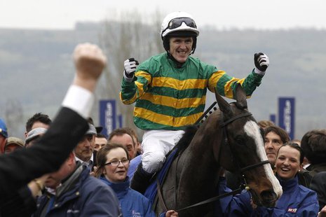 Tony McCoy on Synchronised celebrates as he enters the unsaddling enclosure after winning The Gold Cup at the Cheltenham Festival horse raci Tony McCoy on Synchronised celebrates as he enters the unsaddling enclosure after winning The Gold Cup at the Cheltenham Festival horse raci