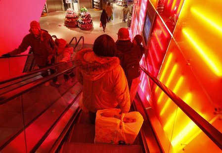 A woman goes down an escalator at a Toys R Us store in New York, December 14, 2010. REUTERS/Shannon Stapleton A woman goes down an escalator at a Toys R Us store in New York, December 14, 2010. REUTERS/Shannon Stapleton