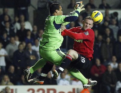 Swansea City's Michel Vorm (L) challenges Manchester United's Wayne Rooney (R) during their English Premier League soccer match at the Liber Swansea City's Michel Vorm (L) challenges Manchester United's Wayne Rooney (R) during their English Premier League soccer match at the Liber