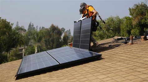 Vivint Solar technicians install solar panels on the roof of a house in Mission Viejo, California, in this October 25, 2013 file photo. Miss Vivint Solar technicians install solar panels on the roof of a house in Mission Viejo, California, in this October 25, 2013 file photo. Miss