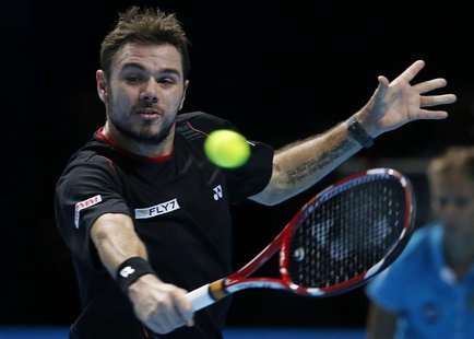 Stanislas Wawrinka of Switzerland hits a return during his men's singles tennis match against Rafael Nadal of Spain at the ATP World Tour Fi Stanislas Wawrinka of Switzerland hits a return during his men's singles tennis match against Rafael Nadal of Spain at the ATP World Tour Fi