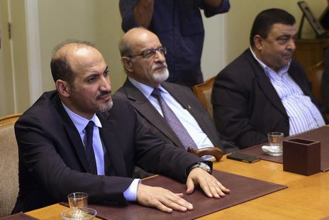 President of the Syrian National Coalition, Ahmad Al-Jarba (L), looks on during a meeting with Arab League Secretary General Nabil al-Arabi President of the Syrian National Coalition, Ahmad Al-Jarba (L), looks on during a meeting with Arab League Secretary General Nabil al-Arabi