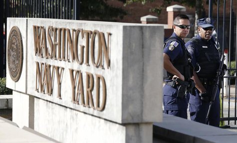A Washington, DC Metropolitan police officer (L) and a Naval District Washington policemen (R) stand guard at the main gate of the Washingto A Washington, DC Metropolitan police officer (L) and a Naval District Washington policemen (R) stand guard at the main gate of the Washingto