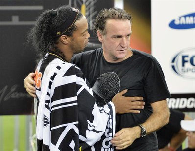 Ronaldinho (L) of Brazil's Atletico Mineiro and team coach Cuca celebrate after winning their Copa Libertadores second leg final soccer matc Ronaldinho (L) of Brazil's Atletico Mineiro and team coach Cuca celebrate after winning their Copa Libertadores second leg final soccer matc
