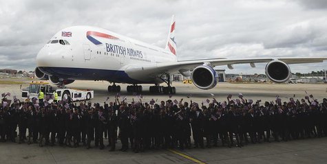 Workers welcome British Airways' new Airbus A380 as it taxis to a hanger after landing at Heathrow airport in London July 4, 2013. REUTERS/P Workers welcome British Airways' new Airbus A380 as it taxis to a hanger after landing at Heathrow airport in London July 4, 2013. REUTERS/P
