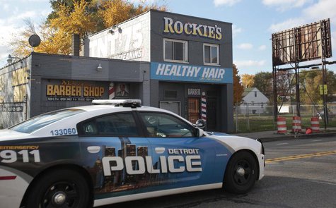 A Detroit Police car drives past a barbershop on Seven Mile Road, where the night before a shooting occurred, in Detroit, Michigan November A Detroit Police car drives past a barbershop on Seven Mile Road, where the night before a shooting occurred, in Detroit, Michigan November