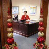 MaryKay Hazelbaker models the holiday pillars in her office doorway at Century Bank and Trust. MaryKay Hazelbaker models the holiday pillars in her office doorway at Century Bank and Trust.