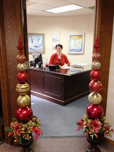 MaryKay Hazelbaker models the holiday pillars in her office doorway at Century Bank and Trust. MaryKay Hazelbaker models the holiday pillars in her office doorway at Century Bank and Trust.