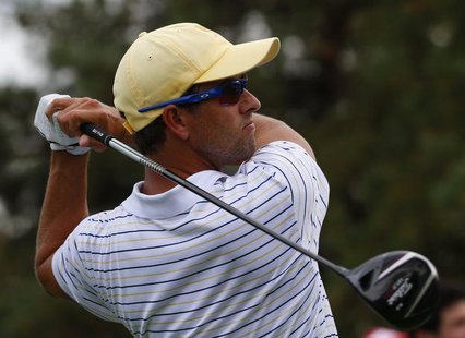 Adam Scott of Australia tees off on the 15th hole while playing his four ball match with partner Hideki Matsuyama of Japan against Tiger Woo Adam Scott of Australia tees off on the 15th hole while playing his four ball match with partner Hideki Matsuyama of Japan against Tiger Woo