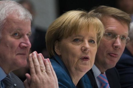 The head of the Christian Democratic Union (CDU) German Chancellor Angela Merkel (C) and the head of the Christian Social Union (CSU) Horst The head of the Christian Democratic Union (CDU) German Chancellor Angela Merkel (C) and the head of the Christian Social Union (CSU) Horst