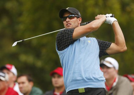 International team member Adam Scott of Australia hits of the 4th tee in his match against Bill Haas of the U.S. during the Singles matches International team member Adam Scott of Australia hits of the 4th tee in his match against Bill Haas of the U.S. during the Singles matches