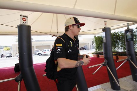 Lotus F1 Formula One driver Kimi Raikkonen of Finland walks through turnstiles before the third practice session of the Abu Dhabi F1 Grand P Lotus F1 Formula One driver Kimi Raikkonen of Finland walks through turnstiles before the third practice session of the Abu Dhabi F1 Grand P