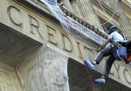 Maintenance workers climb the facade of the Credit Lyonnais bank headquarters in Paris, March 25, 2010. REUTERS/Mal Langsdon Maintenance workers climb the facade of the Credit Lyonnais bank headquarters in Paris, March 25, 2010. REUTERS/Mal Langsdon
