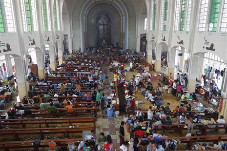 Residents seek refuge inside a Catholic church which has been converted into an evacuation center after super Typhoon Haiyan battered Taclob Residents seek refuge inside a Catholic church which has been converted into an evacuation center after super Typhoon Haiyan battered Taclob
