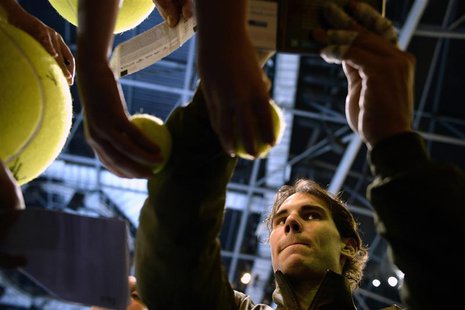 Rafael Nadal of Spain signs autographs after defeating Roger Federer of Switzerland in their men's singles semi-final tennis match at the AT Rafael Nadal of Spain signs autographs after defeating Roger Federer of Switzerland in their men's singles semi-final tennis match at the AT