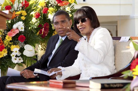 Incoming Jamaican Prime Minister Portia Simpson Miller (R) speaks with outgoing Prime Minister Andrew Holness during her swearing-in ceremon Incoming Jamaican Prime Minister Portia Simpson Miller (R) speaks with outgoing Prime Minister Andrew Holness during her swearing-in ceremon