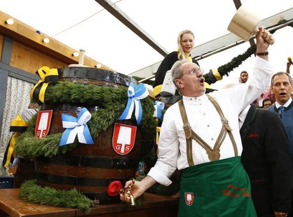 Munich Mayor Christian Ude taps the first barrel of beer during the opening ceremony for the 180th Oktoberfest in Munich September 21, 2013. Munich Mayor Christian Ude taps the first barrel of beer during the opening ceremony for the 180th Oktoberfest in Munich September 21, 2013.