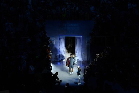 Roger Federer of Switzerland walks onto the court to face Rafael Nadal of Spain in their men's singles semi-final tennis match at the ATP Wo Roger Federer of Switzerland walks onto the court to face Rafael Nadal of Spain in their men's singles semi-final tennis match at the ATP Wo