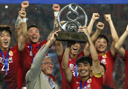 China's Guangzhou Evergrande coach Marcello Lippi (front L) and player Zheng Zhi (front R) hold up the trophy after winning their final matc China's Guangzhou Evergrande coach Marcello Lippi (front L) and player Zheng Zhi (front R) hold up the trophy after winning their final matc