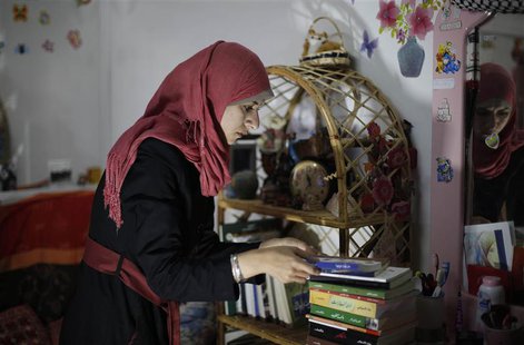Isra Al-Modallal, a spokeswoman of the Hamas government in Gaza, prepares herself before heading to the office, at her house in Rafah refuge Isra Al-Modallal, a spokeswoman of the Hamas government in Gaza, prepares herself before heading to the office, at her house in Rafah refuge