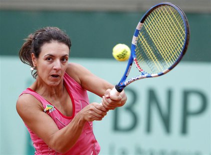 Nuria Llagostera Vives of Spain returns the ball to Anastasia Pavlyuchenkova of Russia during the French Open tennis tournament at the Rolan Nuria Llagostera Vives of Spain returns the ball to Anastasia Pavlyuchenkova of Russia during the French Open tennis tournament at the Rolan