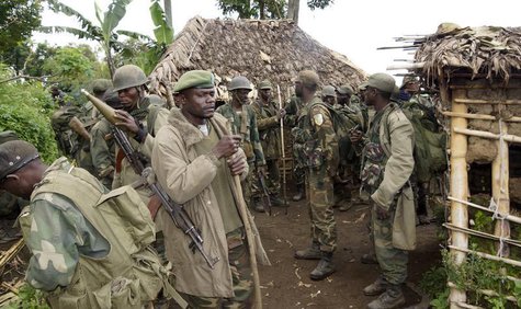 Congolese soldiers gather for a military brief after M23 rebel fighters surrendered in Chanzo village in the Rutshuru territory near the eas Congolese soldiers gather for a military brief after M23 rebel fighters surrendered in Chanzo village in the Rutshuru territory near the eas