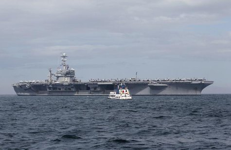 A tugboat approaches the U.S. Navy aircraft carrier George Washington docked after its arrival at a Manila bay October 24, 2012. REUTERS/Rom A tugboat approaches the U.S. Navy aircraft carrier George Washington docked after its arrival at a Manila bay October 24, 2012. REUTERS/Rom