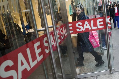 A woman carrying shopping bags enter a shopping store advertising sales in New York, December 24, 2012. REUTERS/Keith Bedford A woman carrying shopping bags enter a shopping store advertising sales in New York, December 24, 2012. REUTERS/Keith Bedford
