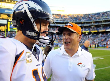 San Diego, CA, USA; Denver Broncos quarterback Peyton Manning (18) celebrates with Denver Broncos interim head coach Jack Del Rio following San Diego, CA, USA; Denver Broncos quarterback Peyton Manning (18) celebrates with Denver Broncos interim head coach Jack Del Rio following