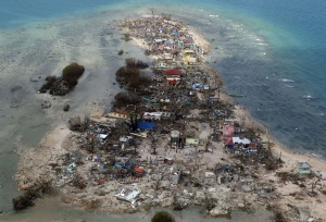 An aerial view of a coastal town, devastated by super Typhoon Haiyan, in Samar province in central Philippines November 11, 2013. Dazed survivors of super Typhoon Haiyan that swept through the central Philippines killing an estimated 10,000 people begged for help and scavenged for food, water and medicine on Monday, threatening to overwhelm military and rescue resources. REUTERS/Erik De Castro An aerial view of a coastal town, devastated by super Typhoon Haiyan, in Samar province in central Philippines November 11, 2013. Dazed survivors of super Typhoon Haiyan that swept through the central Philippines killing an estimated 10,000 people begged for help and scavenged for food, water and medicine on Monday, threatening to overwhelm military and rescue resources. REUTERS/Erik De Castro